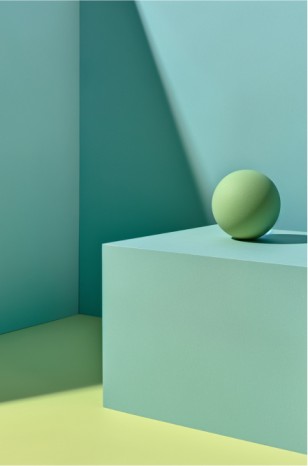 A pastel green cube with a light green sphere on top, sits on a divided yellow and teal surface, against a harmonious green and teal background, creating a minimalist, surreal, and calming scene.