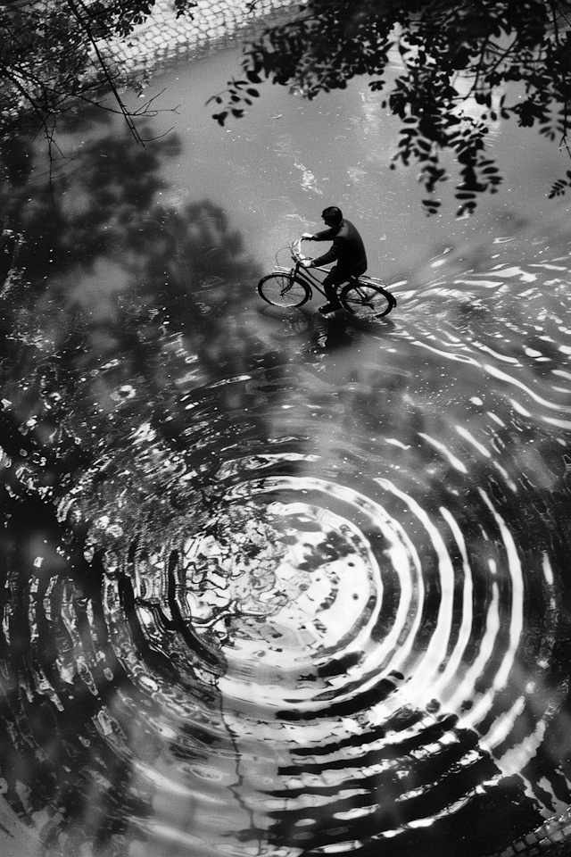 Man Biking in Rain